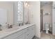 Bright bathroom featuring double sinks, marble countertops, and a glass-enclosed shower at 1580 Cranes Nest Rd, Mount Pleasant, SC 29466