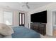 Relaxing bedroom with a large television, ceiling fan, and a door to the outside at 1580 Cranes Nest Rd, Mount Pleasant, SC 29466