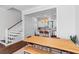 Spacious kitchen and dining area with white cabinets, an island with barstool seating, and wooden table at 1580 Cranes Nest Rd, Mount Pleasant, SC 29466