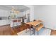 Bright, open kitchen with white cabinets, stainless steel appliances, island seating, and wooden dining table at 1580 Cranes Nest Rd, Mount Pleasant, SC 29466