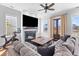 Living room with fireplace, large TV, and access to the porch at 1580 Cranes Nest Rd, Mount Pleasant, SC 29466