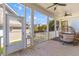 Spacious porch featuring wooden floors, ceiling fans, and a doggie door at 1580 Cranes Nest Rd, Mount Pleasant, SC 29466