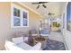 Inviting porch with a fire pit, ceiling fans, and stylish outdoor furniture at 1580 Cranes Nest Rd, Mount Pleasant, SC 29466