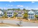 Charming neighborhood street view showcasing two-story homes with inviting front porches at 1580 Cranes Nest Rd, Mount Pleasant, SC 29466