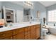 Bathroom with double vanity, a soaking tub, and a large mirror at 1606 Whitby Ln, Charleston, SC 29414