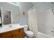 Bright bathroom featuring a shower-tub combo, white fixtures, and a wood vanity at 1606 Whitby Ln, Charleston, SC 29414