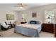 Bedroom featuring neutral walls, carpet, a ceiling fan, and dual windows at 1606 Whitby Ln, Charleston, SC 29414