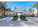 Charming clubhouse exterior with manicured landscaping, accessible parking, and blue sky background at 1606 Whitby Ln, Charleston, SC 29414