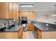 Functional kitchen with wood cabinets, stainless steel appliances, and convenient access to additional space at 1606 Whitby Ln, Charleston, SC 29414