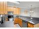 Well-equipped kitchen with wooden cabinets, stainless steel appliances, and plentiful countertop space at 1606 Whitby Ln, Charleston, SC 29414