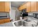 Efficient kitchen with wood cabinetry, stainless steel appliances, and a kitchen sink at 1606 Whitby Ln, Charleston, SC 29414
