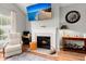 Cozy living room featuring a fireplace, hardwood floors, and a comfortable armchair at 1606 Whitby Ln, Charleston, SC 29414
