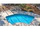 Aerial view of the outdoor pool area with lounge chairs under a pergola, surrounded by lush greenery at 1606 Whitby Ln, Charleston, SC 29414