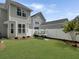 Fenced backyard with green grass, surfboard rack, and minimal landscaping providing a private outdoor space at 1753 Bee Balm Rd, Johns Island, SC 29455