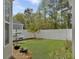 Spacious backyard with a well-manicured lawn, white fence, and beautiful green trees at 1753 Bee Balm Rd, Johns Island, SC 29455