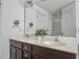 Bathroom featuring double sink vanity with dark wood cabinets and a large mirror reflecting bright, white walls at 1753 Bee Balm Rd, Johns Island, SC 29455