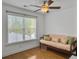 Bedroom with a wooden futon, hardwood floors, ceiling fan, and ample natural light at 1753 Bee Balm Rd, Johns Island, SC 29455