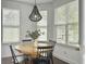 Cozy dining area featuring hardwood floors, white walls, modern lighting, and a wood table set at 1753 Bee Balm Rd, Johns Island, SC 29455