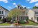 Charming two-story home with a welcoming front porch and balcony, surrounded by lush landscaping and mature trees at 1753 Bee Balm Rd, Johns Island, SC 29455