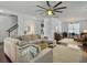 Spacious living room with hardwood floors, white walls, and a sectional sofa, open to other living spaces at 1753 Bee Balm Rd, Johns Island, SC 29455