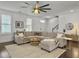 Bright living room features hardwood floors, white walls, and a large comfy sectional sofa at 1753 Bee Balm Rd, Johns Island, SC 29455