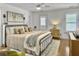 Serene main bedroom featuring hardwood floors, white walls, and a comfortable queen bed at 1753 Bee Balm Rd, Johns Island, SC 29455