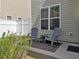 Cozy outdoor patio with two grey chairs and a small rug, perfect for relaxing at 1753 Bee Balm Rd, Johns Island, SC 29455