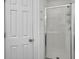 Bathroom featuring a glass-enclosed shower and a white door, complemented by neutral walls at 1753 Bee Balm Rd, Johns Island, SC 29455