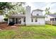 A well-maintained backyard with a screened-in porch, a brick patio, and a chimney in a residential home at 1922 Cedar Petal Ln, Charleston, SC 29414