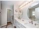 Bright bathroom featuring dual sinks, modern fixtures, decorative mirrors, and ample counter space at 1922 Cedar Petal Ln, Charleston, SC 29414