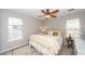 Sunny bedroom featuring two windows, ceiling fan, and neutral walls creates a relaxing atmosphere at 1922 Cedar Petal Ln, Charleston, SC 29414