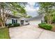 Charming one-story home features a large driveway, attached garage, light gray siding, and well-manicured landscaping at 1922 Cedar Petal Ln, Charleston, SC 29414
