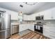Updated kitchen features white cabinets, stainless steel appliances, hardwood floors, and a bright, airy feel at 1922 Cedar Petal Ln, Charleston, SC 29414