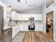Well-designed kitchen with stainless appliances, white cabinets, hardwood floors, and an open layout at 1922 Cedar Petal Ln, Charleston, SC 29414