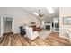 Bright living room features a fireplace, skylights, hardwood floors, neutral paint, and comfortable furnishings at 1922 Cedar Petal Ln, Charleston, SC 29414
