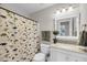 Neutral bathroom with dinosaur shower curtain, granite vanity and a white cabinet at 1938 Oak Tree Ln, Mount Pleasant, SC 29464