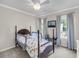 Charming bedroom with neutral walls, two windows, and a wooden bed at 1938 Oak Tree Ln, Mount Pleasant, SC 29464