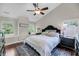 Vaulted bedroom with wood floors, a large bed, and natural light from the window seat at 1938 Oak Tree Ln, Mount Pleasant, SC 29464