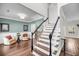 Elegant foyer with hardwood floors, staircase, and tasteful decor, providing a warm welcome to the home at 1938 Oak Tree Ln, Mount Pleasant, SC 29464