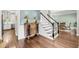Stylish foyer featuring hardwood floors, wainscoting, and a staircase, leading to the upper level of the home at 1938 Oak Tree Ln, Mount Pleasant, SC 29464