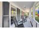 Inviting front porch with classic rocking chairs, perfect for enjoying the outdoors and neighborhood views at 1938 Oak Tree Ln, Mount Pleasant, SC 29464