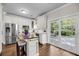 Bright kitchen with white cabinets, stainless steel appliances, and a center island with seating for casual dining at 1938 Oak Tree Ln, Mount Pleasant, SC 29464