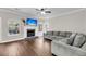 Bright living room features a fireplace, hardwood floors, and a comfortable gray sectional sofa at 1938 Oak Tree Ln, Mount Pleasant, SC 29464