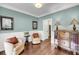 Cozy living room with elegant furnishings, hardwood floors, and soft blue walls, creating a relaxing atmosphere at 1938 Oak Tree Ln, Mount Pleasant, SC 29464