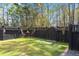 Private backyard featuring a black fence, manicured lawn, and a cozy outdoor dining area at 1992 Kings Gate Ln, Mount Pleasant, SC 29466