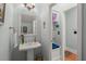 Well-lit half-bathroom features a pedestal sink and neutral-toned walls and finishes at 1992 Kings Gate Ln, Mount Pleasant, SC 29466