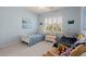 Cozy bedroom featuring two twin beds, natural light, and a sitting area at 1992 Kings Gate Ln, Mount Pleasant, SC 29466