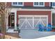 Exterior view of the garage with a light gray door and two chairs in front of the driveway at 1992 Kings Gate Ln, Mount Pleasant, SC 29466