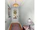 Bright hallway featuring hardwood floors, light blue walls, and a beautiful Tiffany-style hanging light at 1992 Kings Gate Ln, Mount Pleasant, SC 29466