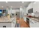 Bright kitchen featuring an island with granite countertops, stainless steel appliances, and white cabinets at 1992 Kings Gate Ln, Mount Pleasant, SC 29466